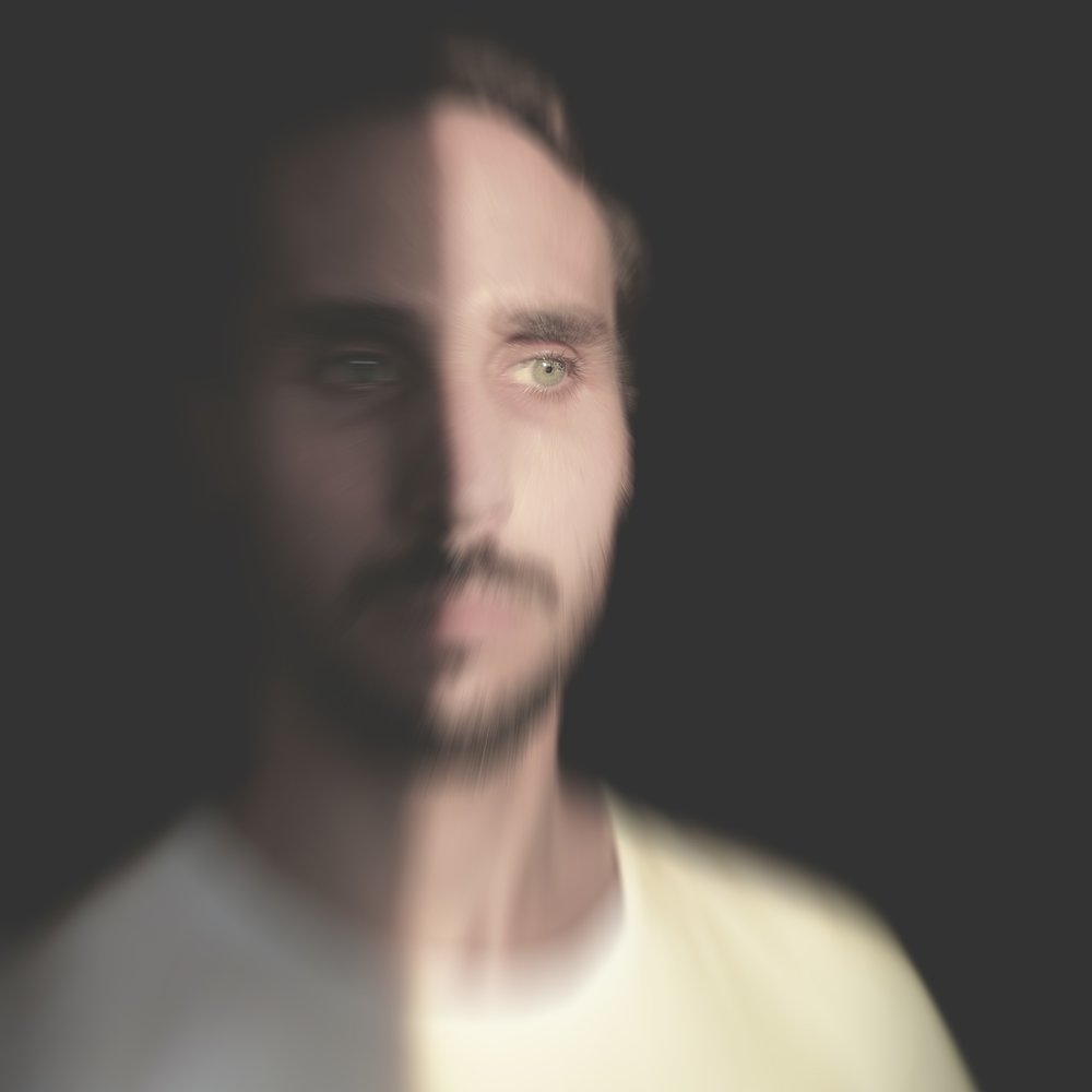 Ingo Mercer, close-up portrait, half in shadow, with motion blur